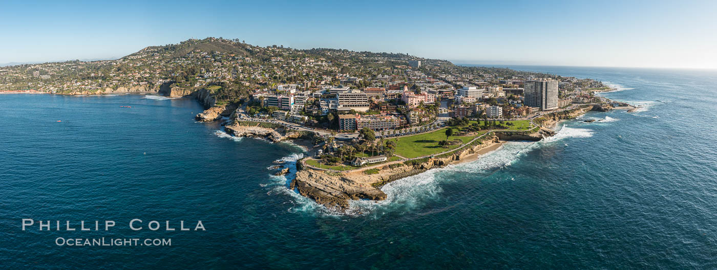 Aerial Panoramic Photo of Point La Jolla and La Jolla Cove, Boomer Beach, Scripps Park. Panoramic aerial photograph of La Jolla Cove and Scripps Parks (center), with La Jolla’s Mount Soledad rising above, La Jolla Shores and La Jolla Caves to the left and the La Jolla Coast with Children’s Pool (Casa Cove) to the right. The undersea reefs of Boomer Beach are seen through the clear, calm ocean waters. This extremely high resolution panorama will print 50″ high by 130″ long with no interpolation