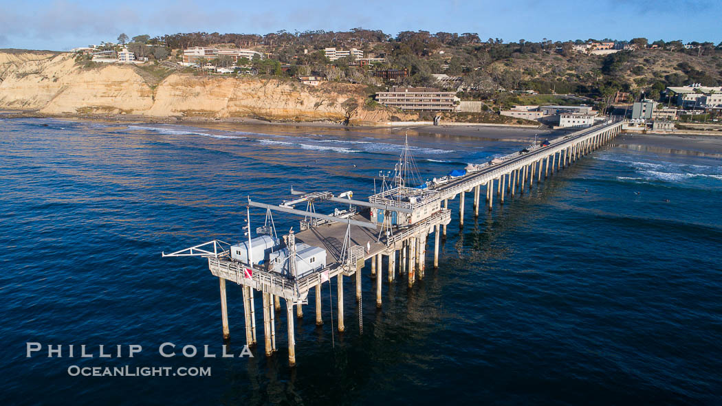 Aerial Photo of Scripps Pier. SIO Pier. The Scripps Institution of Oceanography research pier is 1090 feet long and was built of reinforced concrete in 1988, replacing the original wooden pier built in 1915. The Scripps Pier is home to a variety of sensing equipment above and below water that collects various oceanographic data. The Scripps research diving facility is located at the foot of the pier. Fresh seawater is pumped from the pier to the many tanks and facilities of SIO, including the Birch Aquarium. The Scripps Pier is named in honor of Ellen Browning Scripps, the most significant donor and benefactor of the Institution. La Jolla, California, USA, natural history stock photograph, photo id 38231