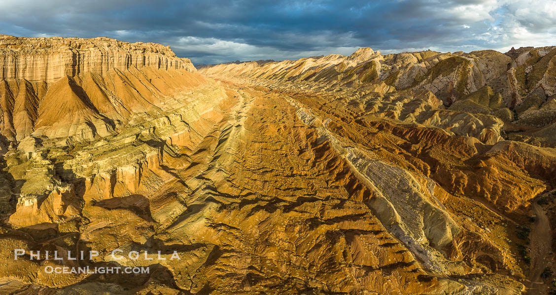 Aerial View of the San Rafael Reef, Utah.  This is a canyon-like section of the San Rafael Reef, photographed at sunrise. The "reef proper" is on the right, with its characteristic triangular flatiron erosion. The canyon in the center is a fold in the Earth's crust affiliated with the boundary of the San Rafael Swell.  The colors seen here arise primarily from Navajo and Wingate sandstone. USA, natural history stock photograph, photo id 39497