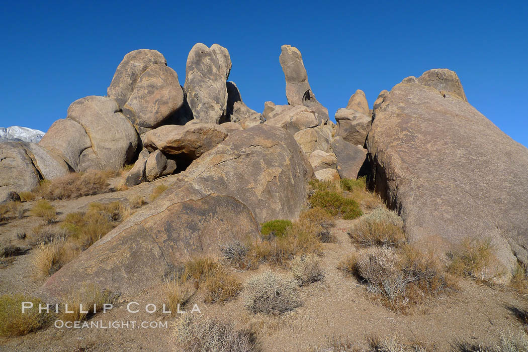 The Alabama Hills, with characteristic curious eroded rock formations formed of ancient granite and metamorphosed rock, next to the Sierra Nevada mountains and the town of Lone Pine. Alabama Hills Recreational Area, California, USA, natural history stock photograph, photo id 21754