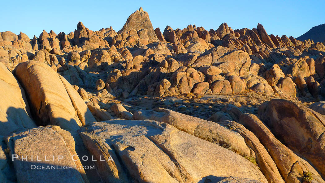 The Alabama Hills, with characteristic curious eroded rock formations formed of ancient granite and metamorphosed rock, next to the Sierra Nevada mountains and the town of Lone Pine. Alabama Hills Recreational Area, California, USA, natural history stock photograph, photo id 21753