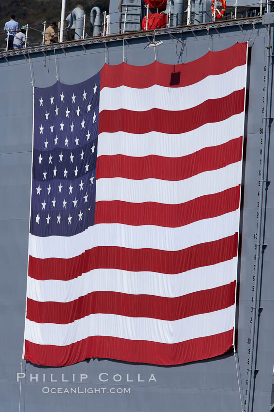 American flag, huge, hanging on the side of a Navy ship. San Diego, California, USA, natural history stock photograph, photo id 21484