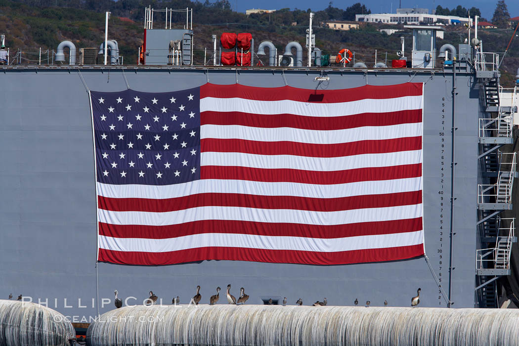 American flag, huge, hanging on the side of a Navy ship. San Diego, California, USA, natural history stock photograph, photo id 21485