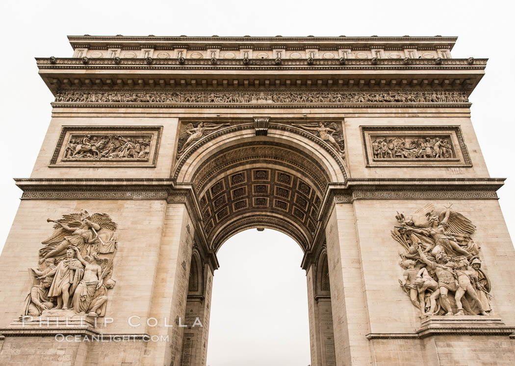 Arc de Triomphe. The Arc de Triomphe (Arc de Triomphe de l'Etoile) is one of the most famous monuments in Paris. It stands in the centre of the Place Charles de Gaulle (originally named Place de l'Etoile), at the western end of the Champs-Elysees. The Arc de Triomphe (in English: "Triumphal Arch") honors those who fought and died for France in the French Revolutionary and the Napoleonic Wars, with the names of all French victories and generals inscribed on its inner and outer surfaces. Beneath its vault lies the Tomb of the Unknown Soldier from World War I. The monument was designed by Jean Chalgrin in 1806, and its iconographic program pitted heroically nude French youths against bearded Germanic warriors in chain mail. It set the tone for public monuments, with triumphant patriotic messages. The monument stands 50 metres (164 ft) in height, 45 m (148 ft) wide and 22 m (72 ft) deep., natural history stock photograph, photo id 28085