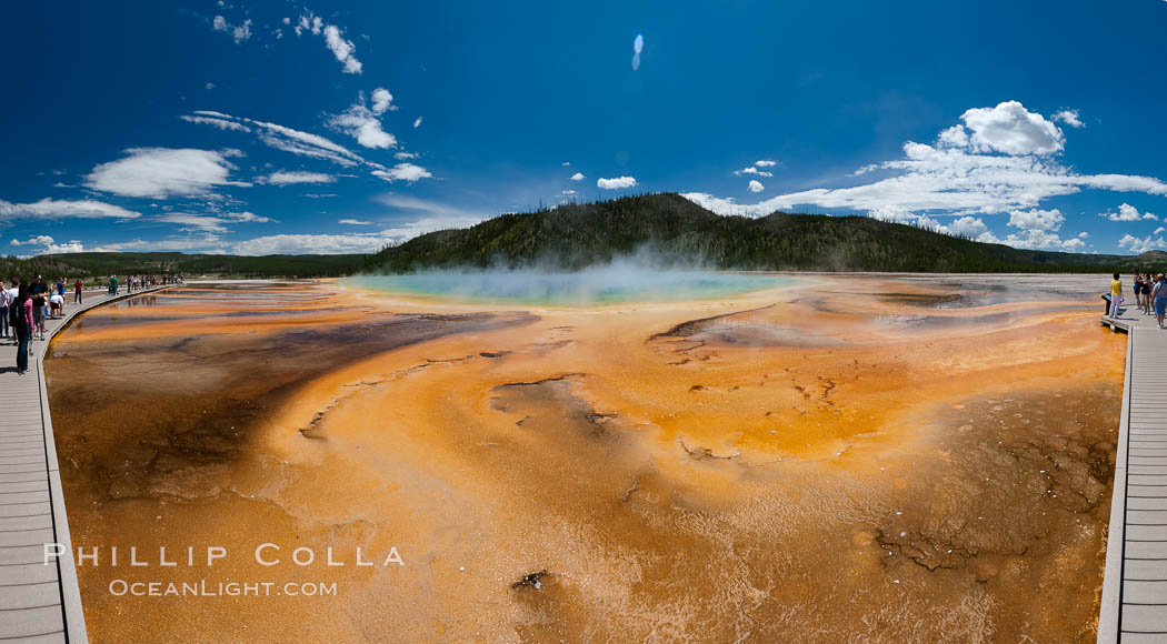 Bacteria mats and Grand Prismatic Spring.  The orange color is due to bacteria which thrive only on the cooler fringes of the hot spring, while the hotter center of the spring hosts blue-colored bacteria. Midway Geyser Basin, Yellowstone National Park, Wyoming, USA, natural history stock photograph, photo id 26958