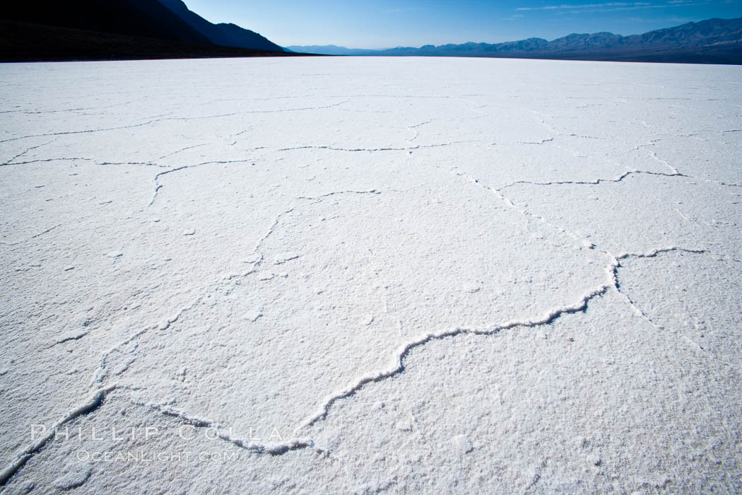 Badwater, California.  Badwater, at 282 feet below sea level, is the lowest point in North America.  9000 square miles of watershed drain into the Badwater basin, to dry and form huge white salt flats. Death Valley National Park, USA, natural history stock photograph, photo id 15622