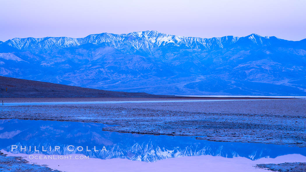 Sunrise lights Telescope Peak as it rises over the salt flats of Badwater, Death Valley.  At 11,049 feet, Telescope Peak is the highest peak in the Panamint Range as well as the highest point in Death Valley National Park.  At 282 feet below sea level, Badwater is the lowest point in North America. California, USA, natural history stock photograph, photo id 20598