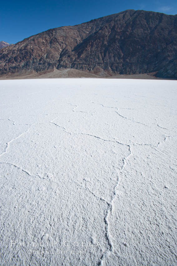 Badwater, California.  Badwater, at 282 feet below sea level, is the lowest point in North America.  9000 square miles of watershed drain into the Badwater basin, to dry and form huge white salt flats. Death Valley National Park, USA, natural history stock photograph, photo id 15592