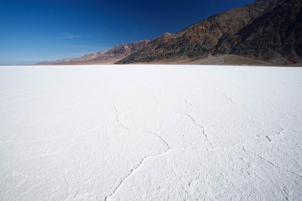 Badwater, California.  Badwater, at 282 feet below sea level, is the lowest point in North America.  9000 square miles of watershed drain into the Badwater basin, to dry and form huge white salt flats. Death Valley National Park, USA, natural history stock photograph, photo id 15612