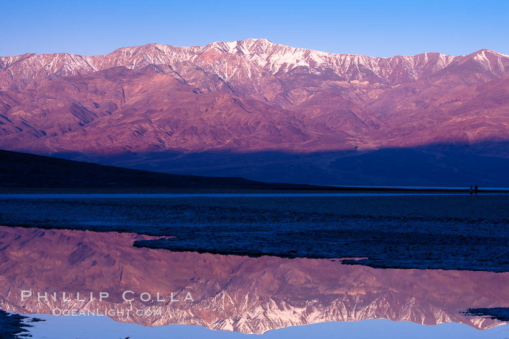 Sunrise lights Telescope Peak as it rises over the salt flats of Badwater, Death Valley.  At 11,049 feet, Telescope Peak is the highest peak in the Panamint Range as well as the highest point in Death Valley National Park.  At 282 feet below sea level, Badwater is the lowest point in North America. California, USA, natural history stock photograph, photo id 20603