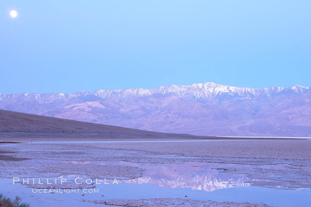 Sunrise lights Telescope Peak as it rises over the salt flats of Badwater, Death Valley.  At 11,049 feet, Telescope Peak is the highest peak in the Panamint Range as well as the highest point in Death Valley National Park.  At 282 feet below sea level, Badwater is the lowest point in North America. California, USA, natural history stock photograph, photo id 20597