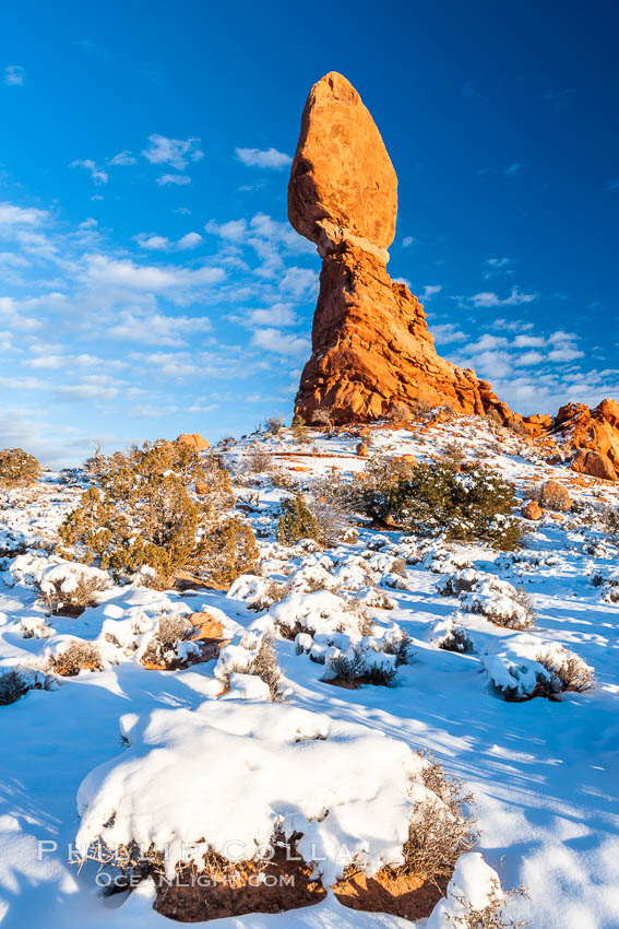 Balanced Rock, a narrow sandstone tower, appears poised to topple.  Sunset, winter. Arches National Park, Utah, USA, natural history stock photograph, photo id 18158