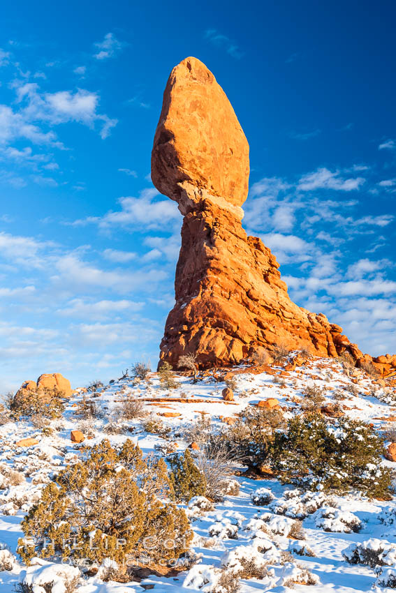 Balanced Rock, a narrow sandstone tower, appears poised to topple.  Sunset, winter. Arches National Park, Utah, USA, natural history stock photograph, photo id 18156