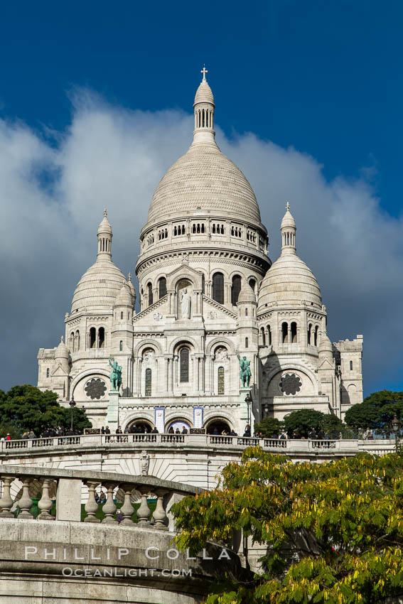 Sacre-Coeur Basilica.  The Basilica of the Sacred Heart of Paris, commonly known as Sacre-Coeur Basilica, is a Roman Catholic church and minor basilica, dedicated to the Sacred Heart of Jesus, in Paris, France. A popular landmark, the basilica is located at the summit of the butte Montmartre, the highest point in the city. Basilique du Sacre-Coeur, natural history stock photograph, photo id 28154