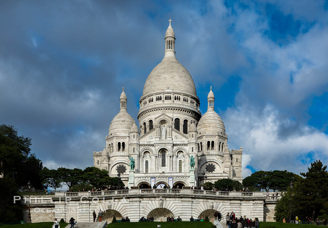 Sacre-Coeur Basilica.  The Basilica of the Sacred Heart of Paris, commonly known as Sacre-Coeur Basilica, is a Roman Catholic church and minor basilica, dedicated to the Sacred Heart of Jesus, in Paris, France. A popular landmark, the basilica is located at the summit of the butte Montmartre, the highest point in the city. Basilique du Sacre-Coeur, natural history stock photograph, photo id 28155