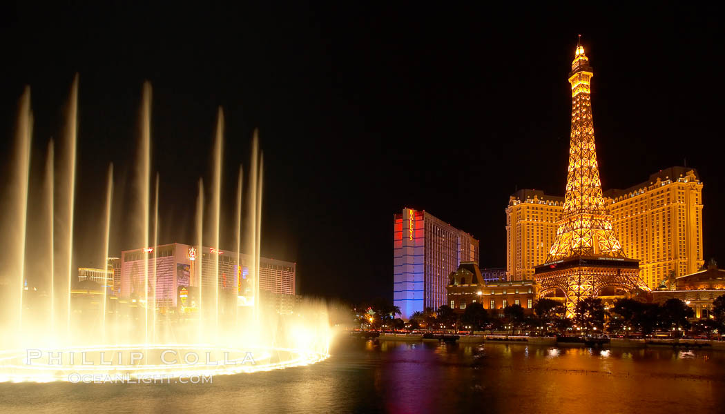 The Bellagio Hotel fountains light up the reflection pool as the half-scale replica of the Eiffel Tower at the Paris Hotel in Las Vegas rises above them, at night. Nevada, USA, natural history stock photograph, photo id 20560