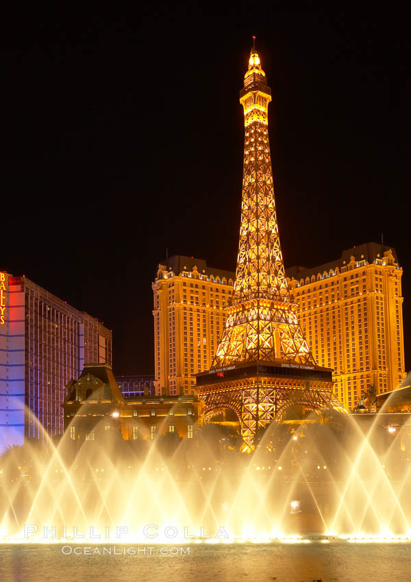 The Bellagio Hotel fountains light up the reflection pool as the half-scale replica of the Eiffel Tower at the Paris Hotel in Las Vegas rises above them, at night. Nevada, USA, natural history stock photograph, photo id 20580