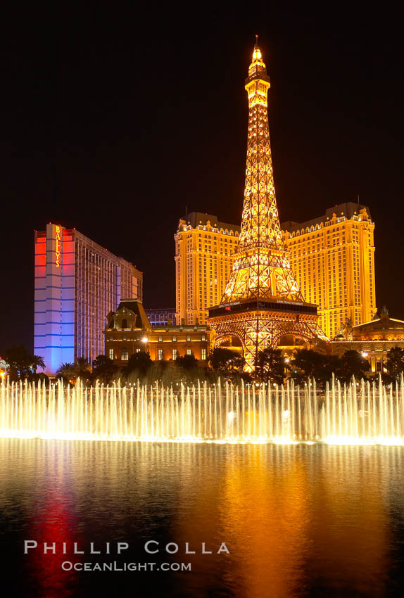 The Bellagio Hotel fountains light up the reflection pool as the half-scale replica of the Eiffel Tower at the Paris Hotel in Las Vegas rises above them, at night. Nevada, USA, natural history stock photograph, photo id 20584