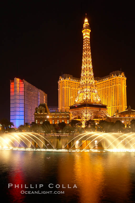 The Bellagio Hotel fountains light up the reflection pool as the half-scale replica of the Eiffel Tower at the Paris Hotel in Las Vegas rises above them, at night. Nevada, USA, natural history stock photograph, photo id 20579