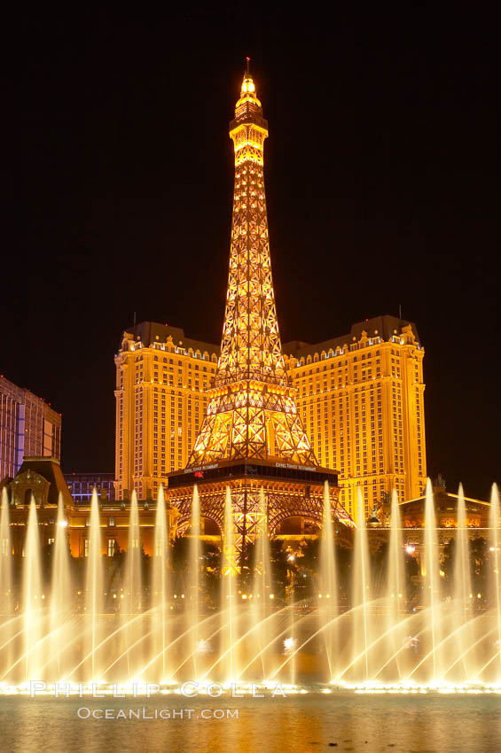 The Bellagio Hotel fountains light up the reflection pool as the half-scale replica of the Eiffel Tower at the Paris Hotel in Las Vegas rises above them, at night. Nevada, USA, natural history stock photograph, photo id 20585
