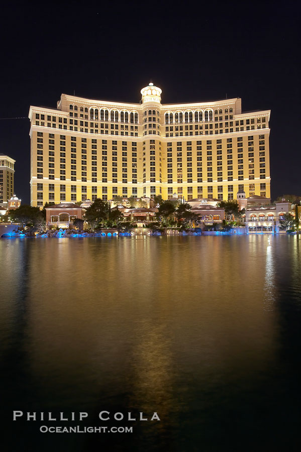 The Bellagio Hotel reflected in the fountain pool at night.  The Bellagio Hotel fountains are one of the most popular attractions in Las Vegas, showing every half hour or so throughout the day, choreographed to famous Hollywood music., natural history stock photograph, photo id 20574