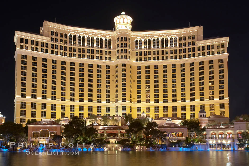 The Bellagio Hotel reflected in the fountain pool at night.  The Bellagio Hotel fountains are one of the most popular attractions in Las Vegas, showing every half hour or so throughout the day, choreographed to famous Hollywood music. Nevada, USA, natural history stock photograph, photo id 20556