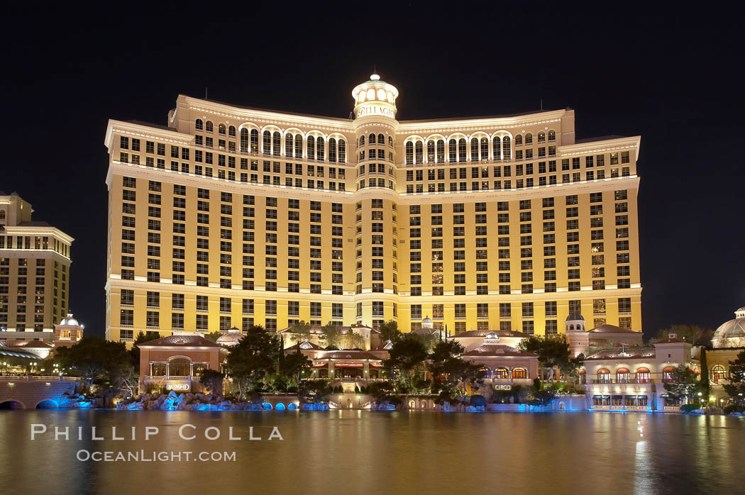 The Bellagio Hotel reflected in the fountain pool at night.  The Bellagio Hotel fountains are one of the most popular attractions in Las Vegas, showing every half hour or so throughout the day, choreographed to famous Hollywood music. Nevada, USA, natural history stock photograph, photo id 20572