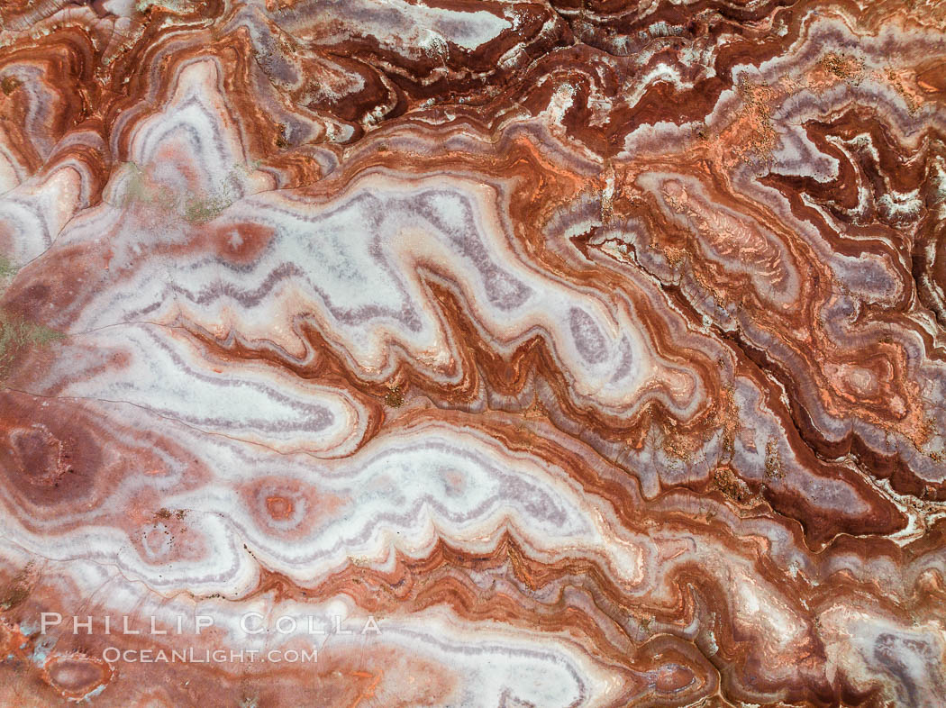 Fantastic colorful sedimentary patterns, Bentonite layers are seen as striations exposed in the Utah Badlands. The Bentonite Hills are composed of the Brushy Basin shale member of the Morrison Formation. This layer was formed during Jurassic times when mud, silt, fine sand, and volcanic ash were deposited in swamps and lakes. Aerial photograph. USA, natural history stock photograph, photo id 38030