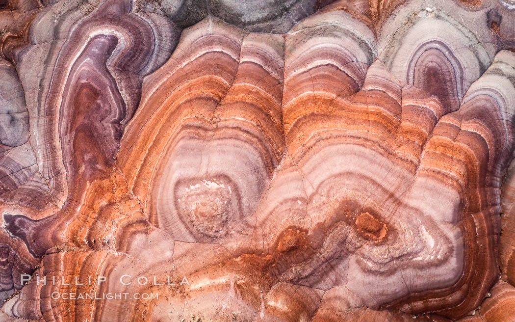 Fantastic colorful sedimentary patterns, Bentonite layers are seen as striations exposed in the Utah Badlands. The Bentonite Hills are composed of the Brushy Basin shale member of the Morrison Formation. This layer was formed during Jurassic times when mud, silt, fine sand, and volcanic ash were deposited in swamps and lakes. Aerial photograph. USA, natural history stock photograph, photo id 38029