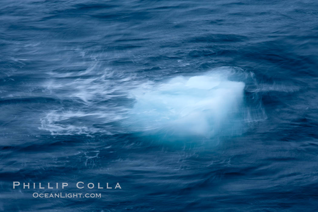 Bergy bit of ice, bobbing in the ocean, blurred due to time exposure. Coronation Island, South Orkney Islands, Southern Ocean, natural history stock photograph, photo id 24942