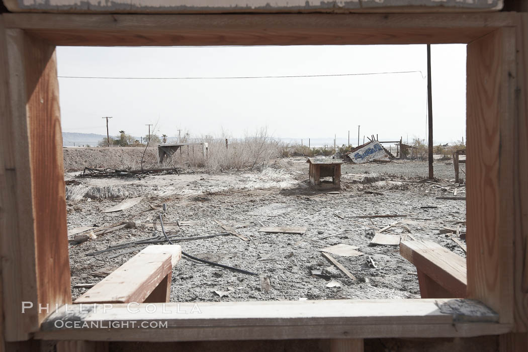 Bombay Beach, lies alongside and below the flood level of the Salton Sea, so that it floods occasionally when the Salton Sea rises.  A part of Bombay Beach is composed of derelict old trailer homes, shacks and wharfs, slowly sinking in the mud and salt. Imperial County, California, USA, natural history stock photograph, photo id 22496