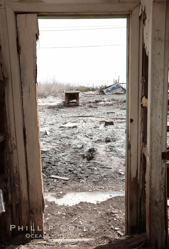 Bombay Beach, lies alongside and below the flood level of the Salton Sea, so that it floods occasionally when the Salton Sea rises.  A part of Bombay Beach is composed of derelict old trailer homes, shacks and wharfs, slowly sinking in the mud and salt. Imperial County, California, USA, natural history stock photograph, photo id 22500