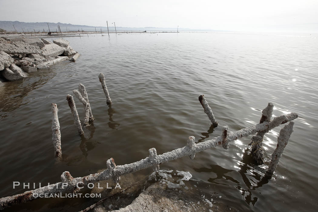 Bombay Beach, lies alongside and below the flood level of the Salton Sea, so that it floods occasionally when the Salton Sea rises.  A part of Bombay Beach is composed of derelict old trailer homes, shacks and wharfs, slowly sinking in the mud and salt. Imperial County, California, USA, natural history stock photograph, photo id 22487