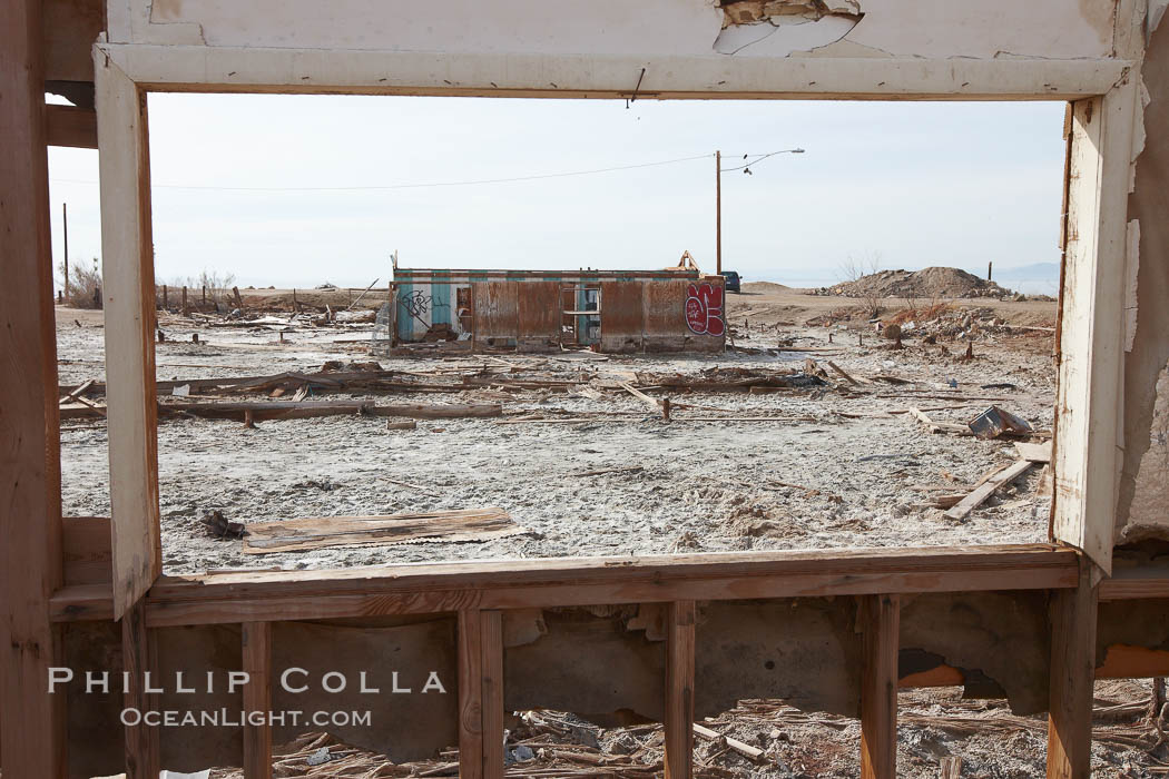 Bombay Beach, lies alongside and below the flood level of the Salton Sea, so that it floods occasionally when the Salton Sea rises.  A part of Bombay Beach is composed of derelict old trailer homes, shacks and wharfs, slowly sinking in the mud and salt. Imperial County, California, USA, natural history stock photograph, photo id 22495