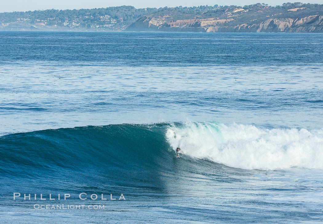 Bodysurfer on large Boomer Beach wave, winter swell, La Jolla, Black's Beach and Torrey Pines in the distance. California, USA, natural history stock photograph, photo id 30196