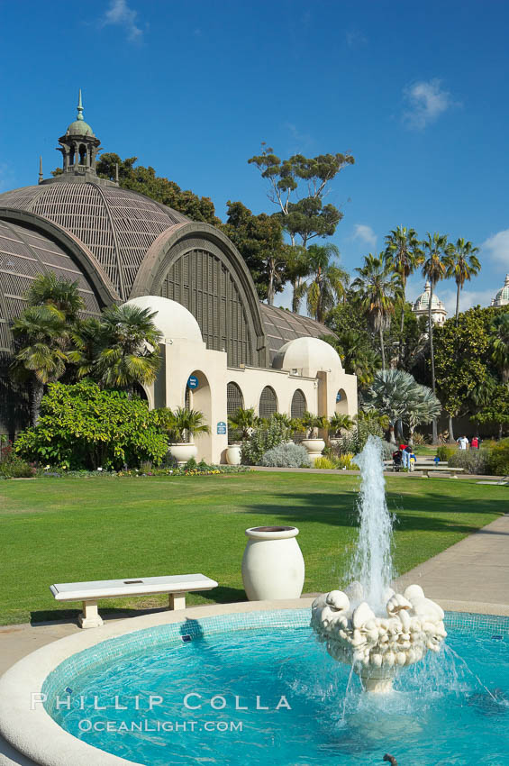 The Botanical Building in Balboa Park, San Diego.  The Botanical Building, at 250 feet long by 75 feet wide and 60 feet tall, was the largest wood lath structure in the world when it was built in 1915 for the Panama-California Exposition. The Botanical Building, located on the Prado, west of the Museum of Art, contains about 2,100 permanent tropical plants along with changing seasonal flowers. The Lily Pond, just south of the Botanical Building, is an eloquent example of the use of reflecting pools to enhance architecture. The 193 by 43 foot pond and smaller companion pool were originally referred to as Las Lagunas de las Flores (The Lakes of the Flowers) and were designed as aquatic gardens. The pools contain exotic water lilies and lotus which bloom spring through fall.  Balboa Park, San Diego. USA, natural history stock photograph, photo id 14582