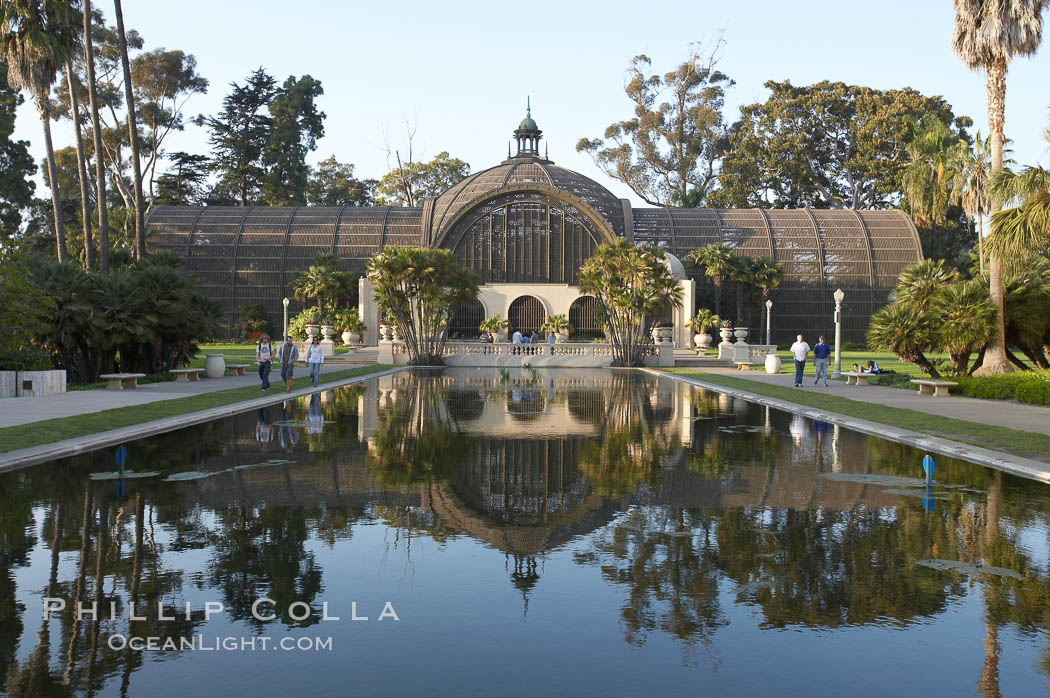 The Botanical Building in Balboa Park, San Diego.  The Botanical Building, at 250 feet long by 75 feet wide and 60 feet tall, was the largest wood lath structure in the world when it was built in 1915 for the Panama-California Exposition. The Botanical Building, located on the Prado, west of the Museum of Art, contains about 2,100 permanent tropical plants along with changing seasonal flowers. The Lily Pond, just south of the Botanical Building, is an eloquent example of the use of reflecting pools to enhance architecture. The 193 by 43 foot pond and smaller companion pool were originally referred to as Las Lagunas de las Flores (The Lakes of the Flowers) and were designed as aquatic gardens. The pools contain exotic water lilies and lotus which bloom spring through fall.  Balboa Park, San Diego. USA, natural history stock photograph, photo id 11273