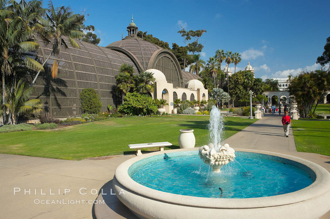 The Botanical Building in Balboa Park, San Diego.  The Botanical Building, at 250 feet long by 75 feet wide and 60 feet tall, was the largest wood lath structure in the world when it was built in 1915 for the Panama-California Exposition. The Botanical Building, located on the Prado, west of the Museum of Art, contains about 2,100 permanent tropical plants along with changing seasonal flowers. The Lily Pond, just south of the Botanical Building, is an eloquent example of the use of reflecting pools to enhance architecture. The 193 by 43 foot pond and smaller companion pool were originally referred to as Las Lagunas de las Flores (The Lakes of the Flowers) and were designed as aquatic gardens. The pools contain exotic water lilies and lotus which bloom spring through fall.  Balboa Park, San Diego. USA, natural history stock photograph, photo id 14581