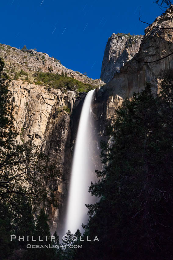 Bridalveil Falls at Night, lit by full moon with a rainbow forming in its spray, dropping 620 into Yosemite Valley, displaying peak water flow in spring months from deep snowpack and warm weather melt. Yosemite National Park, California, USA, natural history stock photograph, photo id 27753