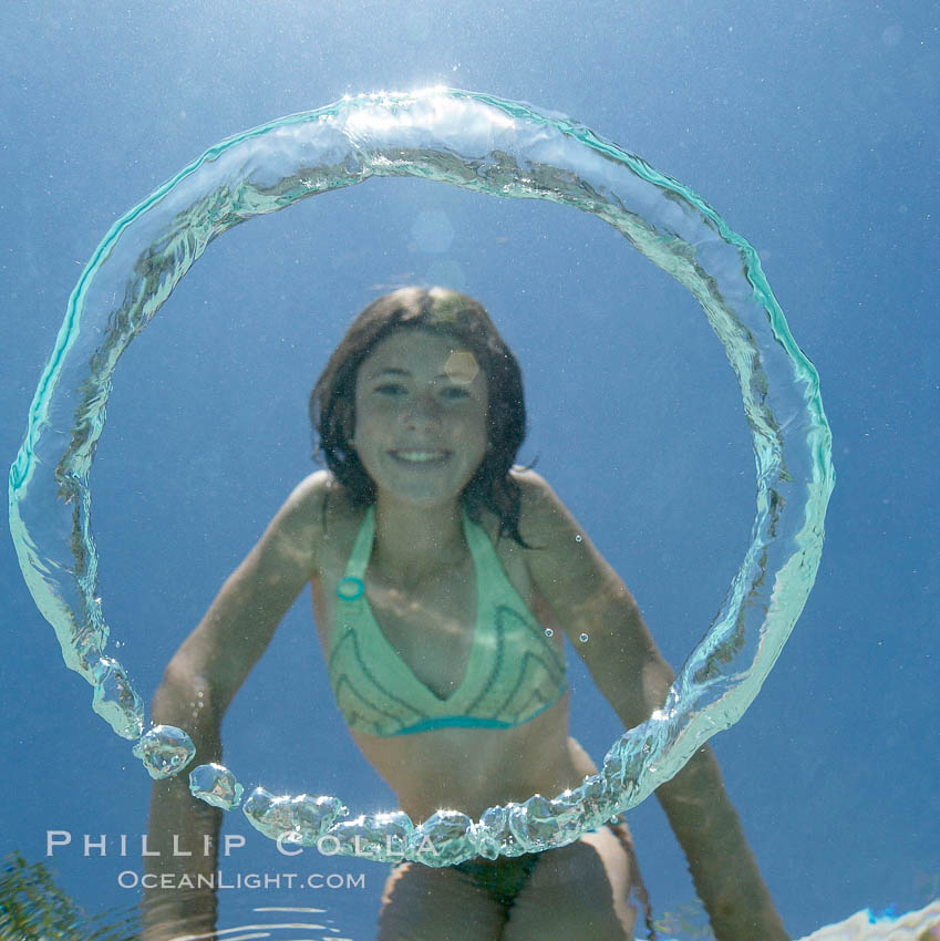 A bubble ring. A young girl watches as a bubble ring ascends through the water toward her., natural history stock photograph, photo id 20785