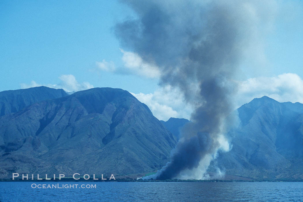 West Maui and smoke from burning cut sugar cane.  Cane fields are often burned to clear cane cuttings, which produces huge amounts of smoke and ash. Hawaii, USA, natural history stock photograph, photo id 04550