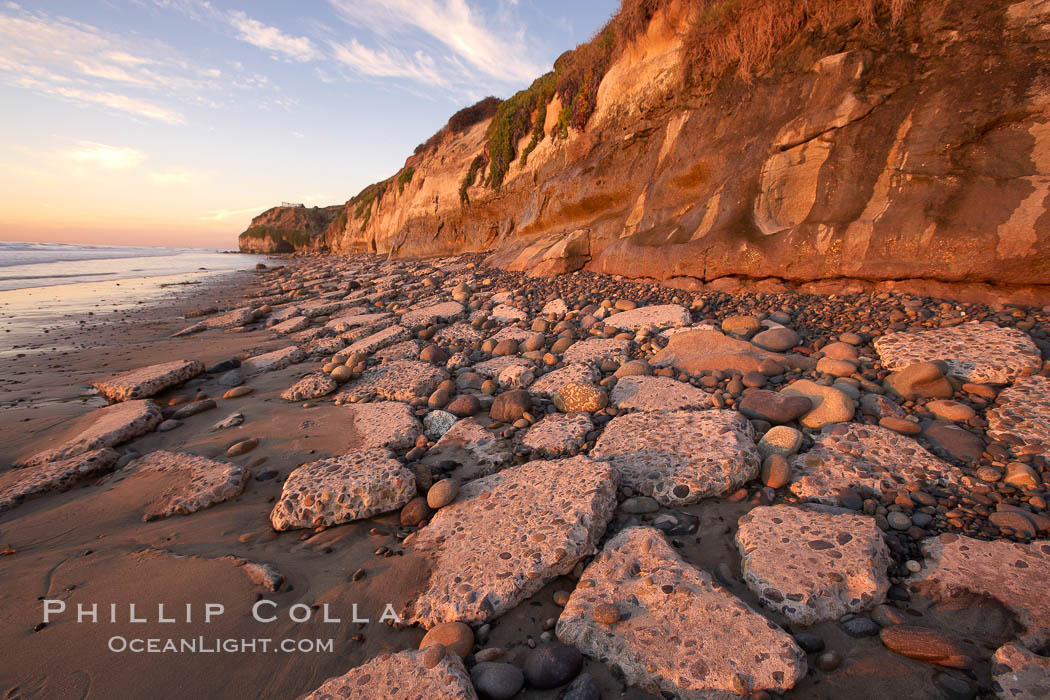 Remains of the old historic "Coast Highway 101", undermined as the bluff upon which it was built eroded away, now broken into pieces of concrete and asphalt blocks and fallen down the sea cliffs, lying on the beach. Carlsbad, California, USA, natural history stock photograph, photo id 22191