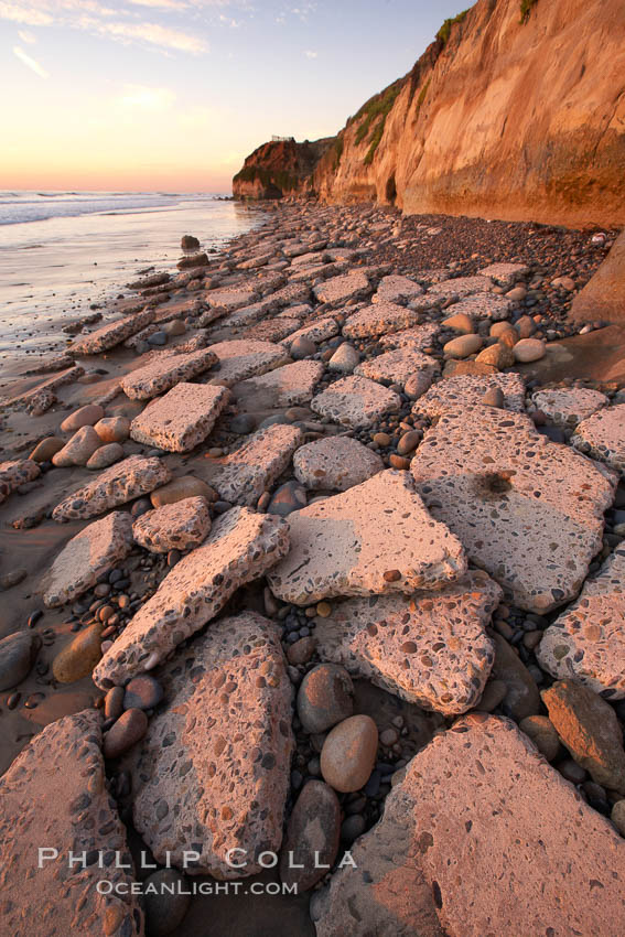 Remains of the old historic "Coast Highway 101", undermined as the bluff upon which it was built eroded away, now broken into pieces of concrete and asphalt blocks and fallen down the sea cliffs, lying on the beach. Carlsbad, California, USA, natural history stock photograph, photo id 22193