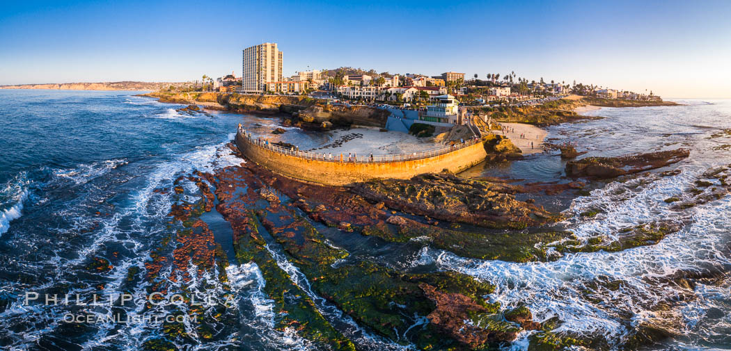 Childrens Pool and La Jolla coastline at sunset, aerial panorama, showing underwater reef exposed at King Low Tide