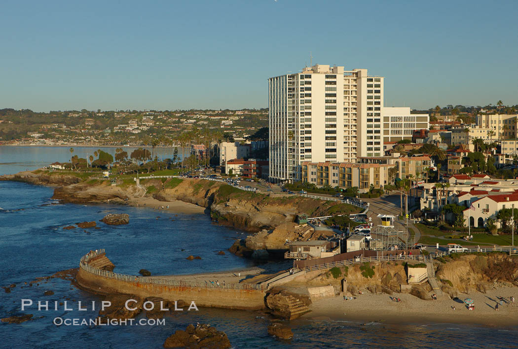 The Children's Pool in La Jolla, also known as Casa Cove, is a small pocket cove protected by a curving seawall, with the rocky coastline and cottages and homes of La Jolla seen behind it. California, USA, natural history stock photograph, photo id 22360