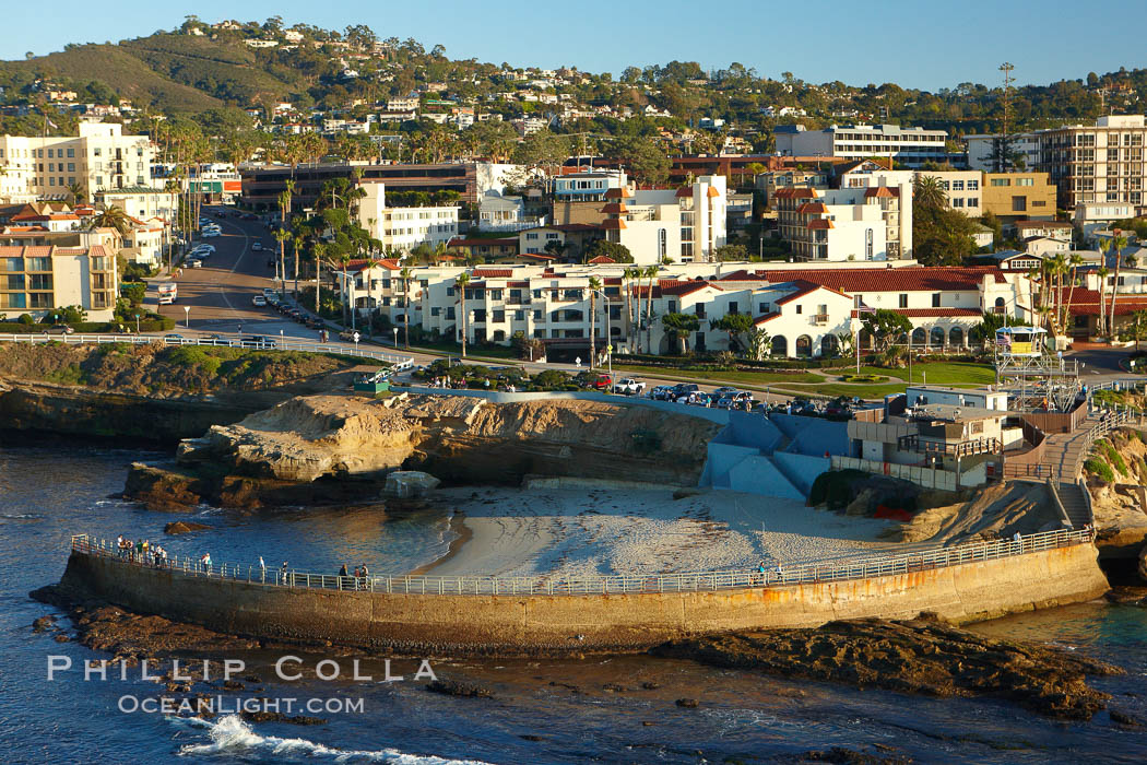 The Children's Pool in La Jolla, also known as Casa Cove, is a small pocket cove protected by a curving seawall, with the rocky coastline and cottages and homes of La Jolla seen behind it. California, USA, natural history stock photograph, photo id 22395