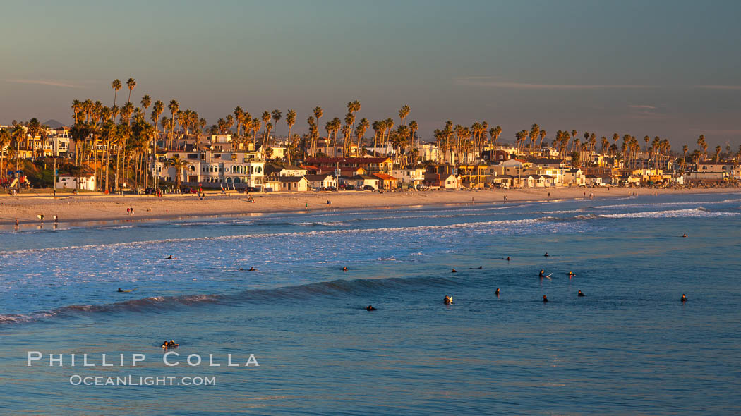 The coast of Oceanside California, waves and surfers, beach houses, just before sunset, winter, looking south. Oceanside Pier, USA, natural history stock photograph, photo id 27606
