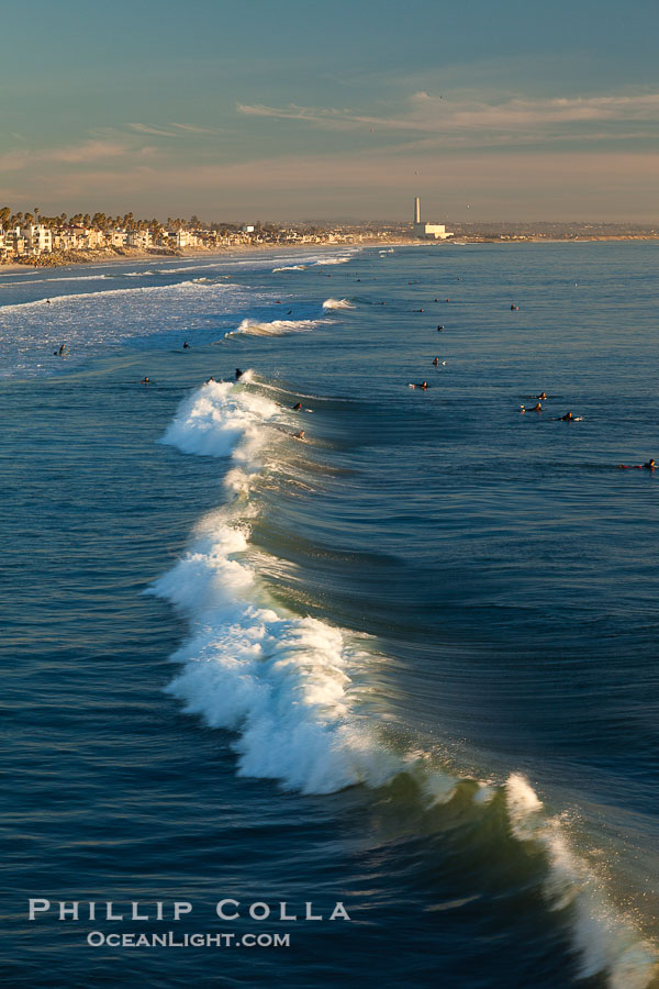 The coast of Oceanside California, waves and surfers, beach houses, just before sunset, winter, looking south., natural history stock photograph, photo id 27600