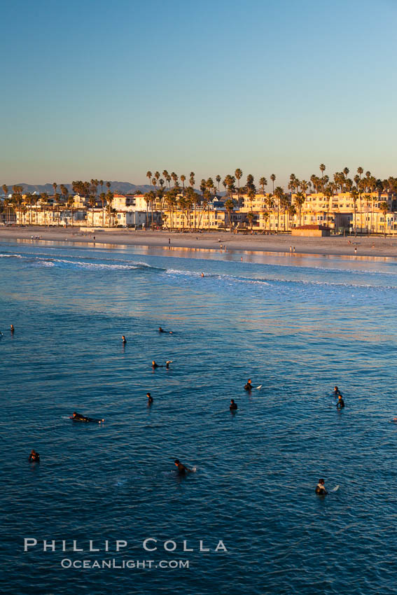 The coast of Oceanside California, waves and surfers, beach houses, just before sunset, winter, looking north. Oceanside Pier, USA, natural history stock photograph, photo id 27604