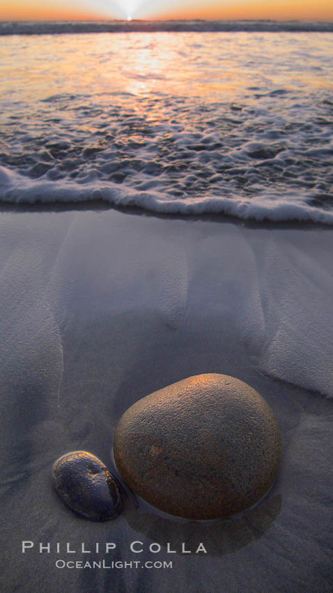 Cobblestone lies on the sand at the ocean's edge, sunset., natural history stock photograph, photo id 21778